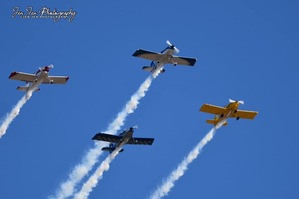 Precision Flight Team aerobatic formation trailing smoke over Cullman